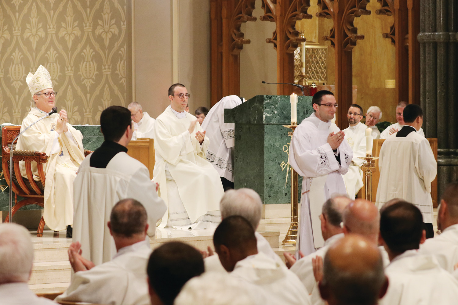 Bishop Tobin leads everyone in attendance in applauding Father Dufour on the occasion of his ordination to the priesthood.